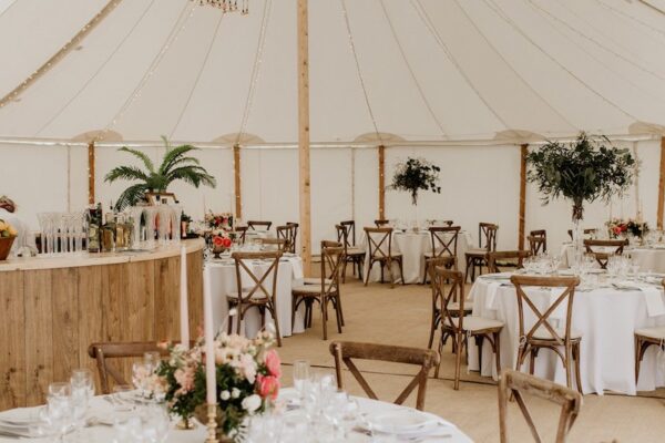 Round tables inside sailcloth tent